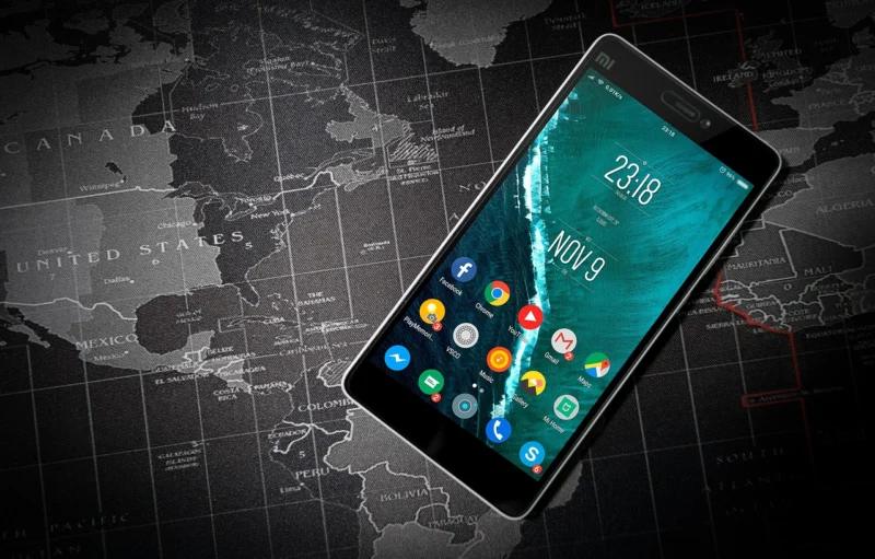 Woman holding smartphone displaying local map with nearby stores, illustrating navigational search intent