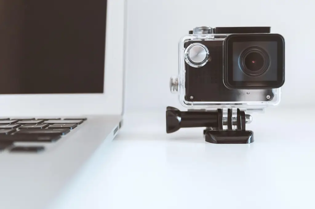 Laptop and video camera on desk, illustrating video vs text content creation